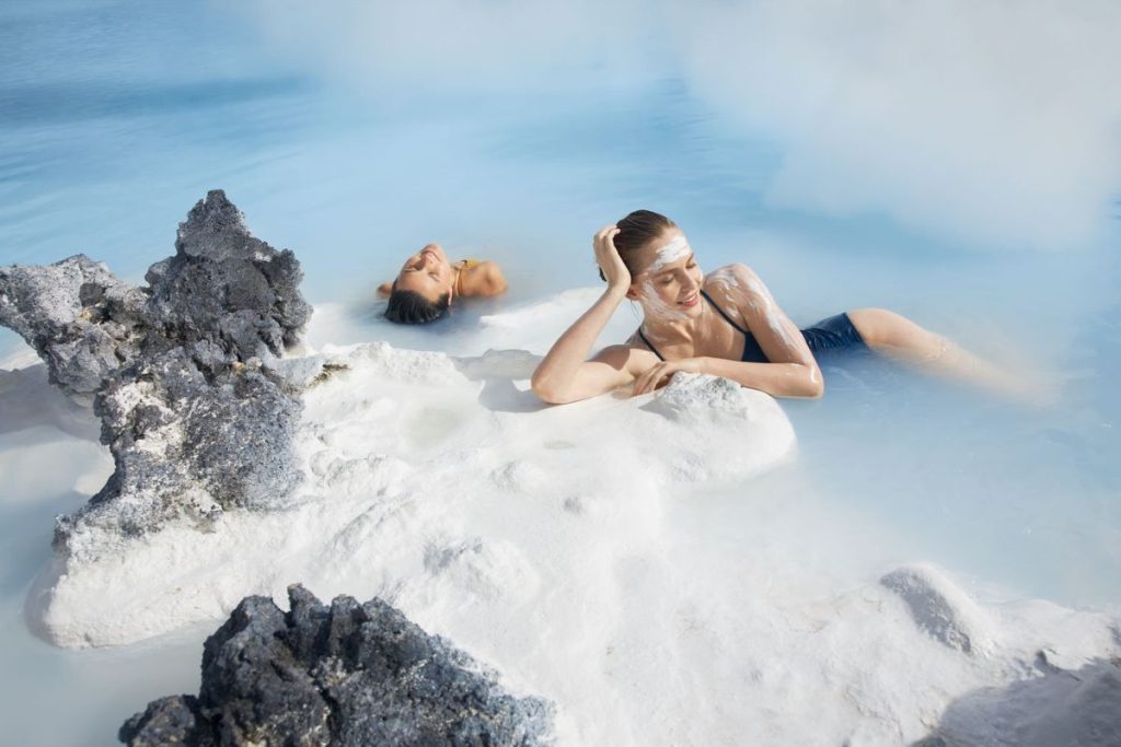 2 women relaxing in world famous blue lagoon in iceland